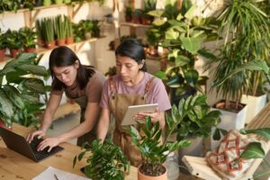 Female Plants Sellers Doing E-Commerce at Their Workplace